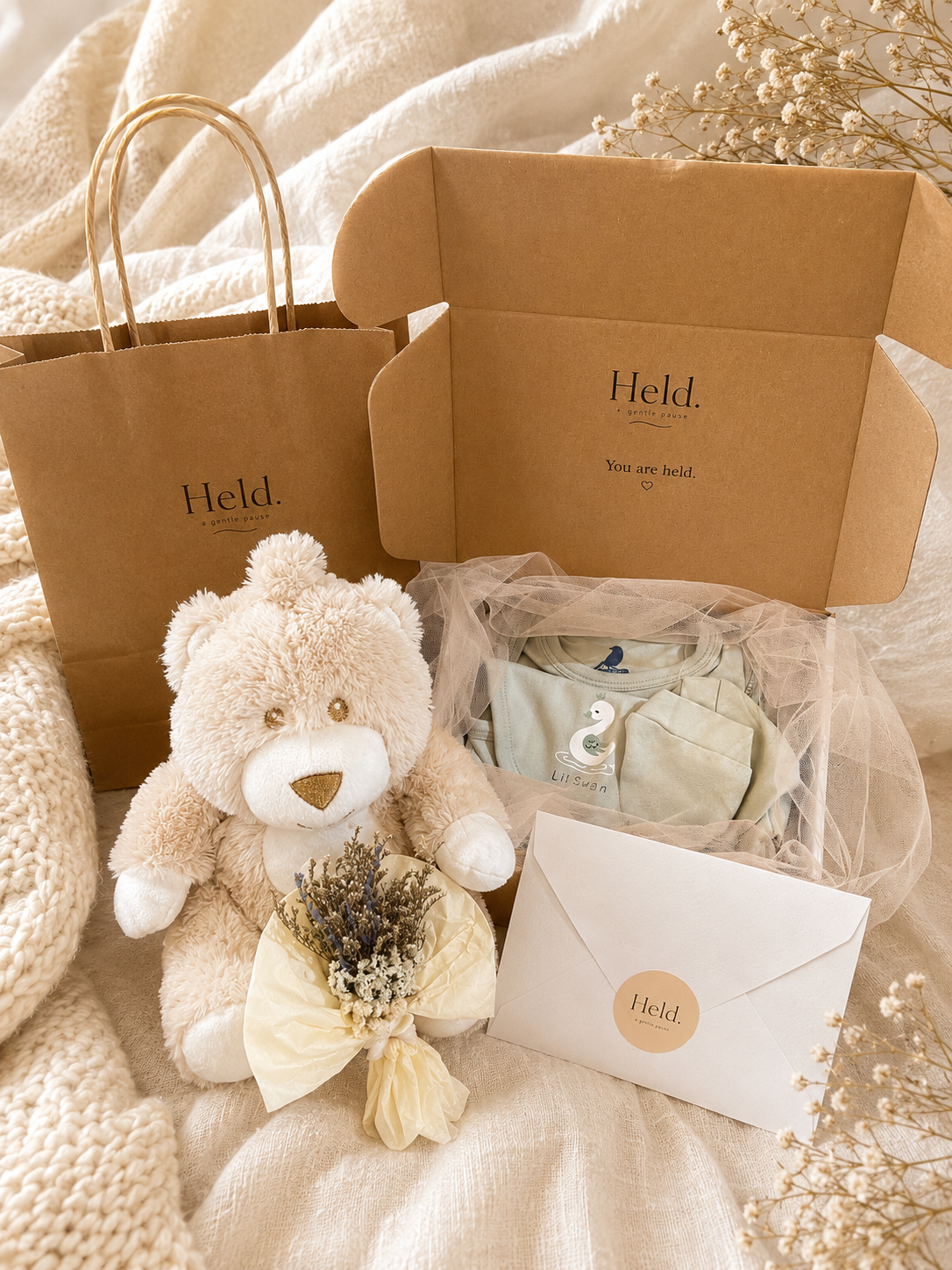 Held. Welcome Little Sunshine new baby gift box with newborn clothing set